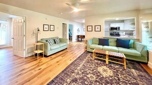 A spacious living room with two sofas, a coffee table, and a patterned rug. - Near McKinney Square!  Charming 3 BR house with garage and huge yard (McKinney)