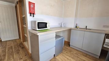 Mini-fridge, microwave, cookware/dishes/utensils