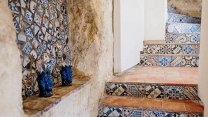 A staircase with patterned tiles and blue vases on the wall. - La Luna sul Porto by Biddizzi Rari - at the port, near the sea and the center (Sciacca)