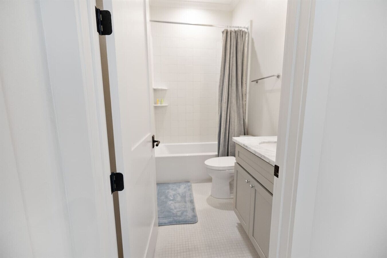 A bathroom with a toilet, sink, and shower.