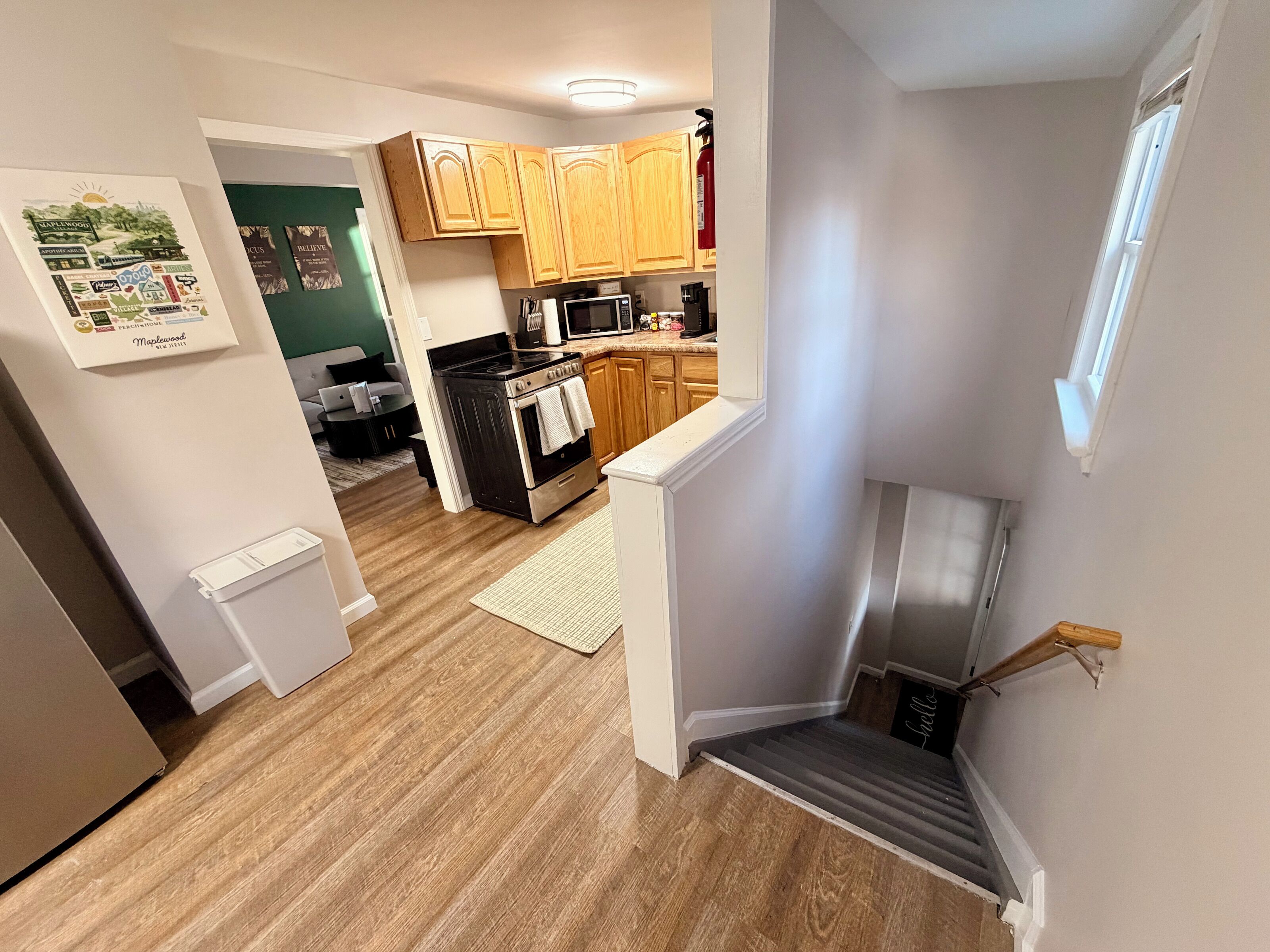 A kitchen with wooden cabinets, a microwave, and a stove.