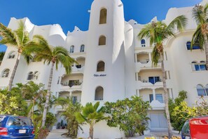 A white building with balconies and palm trees, labeled "Villa Astori." - Beachfront Paradise Mykonos 204A (San José del Cabo)