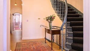 A staircase with a handrail and a carpeted floor. - Deluxe Family Room (Room 1 - Ground Floor) (Edinburgh)