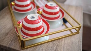 A tray with red and white teapots and cups, gold handles, and a gold frame. - Deluxe Family Room (Room 3 - Lower Ground Floor) (Edinburgh)