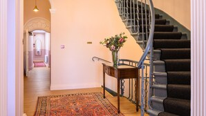 A staircase with a handrail and a carpeted floor. - Deluxe Family Room (Room 8 - Ground Floor) (Edinburgh)
