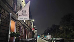 A building with a flag reading "Queen Charlotte Guest House." - Deluxe Family Room (Room 8 - Ground Floor) (Edinburgh)