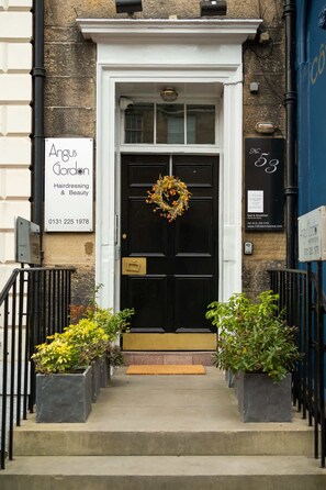 A black door with a wreath, a sign for Angus Gordon Hairdressing & Beauty, and a number 53 sign on the building. - Large Family Room (2nd Floor - Room 1) (Edinburgh)
