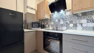 Comfort Apartment, 1 Bedroom | Private kitchen | Full-size fridge, microwave, oven, stovetop