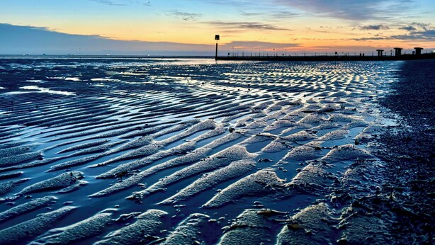 A beach with wet sand patterns and a distant pier. - Humberside Apartments (Cleethorpes)