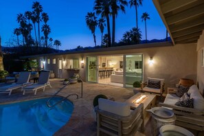 A pool area with lounge chairs, a hot tub, and a patio with seating. - The Dean - Modern Zen Retreat in Deepwell (Palm Springs)