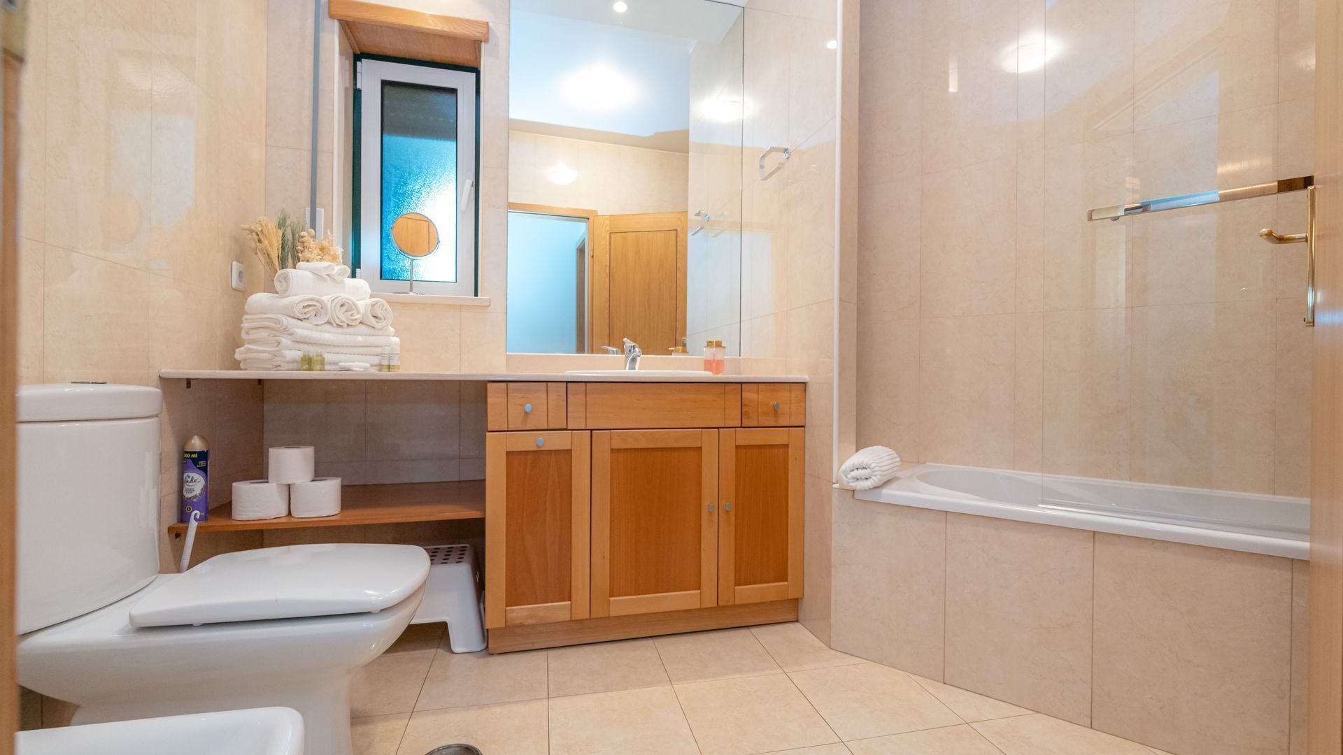 A modern bathroom with a toilet, sink, and shower.