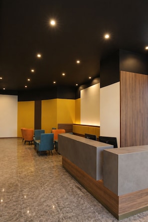 A reception area with a counter, chairs, and a tiled floor.