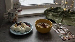 A window with a view of a snowy landscape, a mug, a plate with food, and a bowl on a table. - The Blackbird Inn on Rice Lake (Rice Lake)