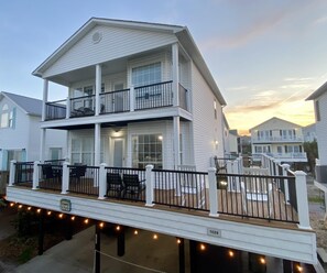 A two-story house with a balcony, a deck, and a number '1028' sign. - Ocean Lakes 1028, 5 Bdrm/4 Bath near ocean Golf Cart (Myrtle Beach)