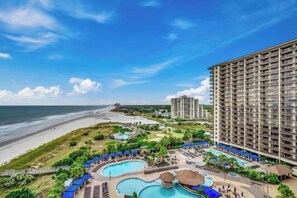 A hotel with a large pool area, a beach view, and multiple buildings. - Oceanfront Villa | Pool Access | North Myrtle Beach Views (North Myrtle Beach)