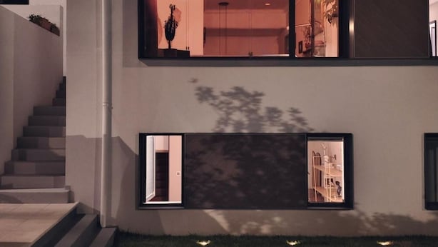A modern two-story house with a visible staircase, a swimming pool, and a well-lit interior. - ModernInfluence (Porto)