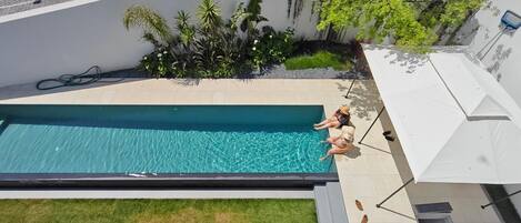 Seasonal outdoor pool, open 9:30 AM to 7:30 PM, pool umbrellas