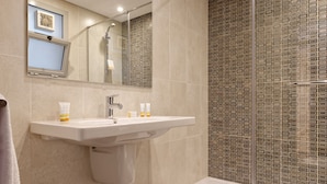 A bathroom with a sink, mirror, and shower. - Vesta - Luxury Apt - 2Br - Cfc (XXXI) (New Cairo City)