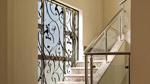 A marble staircase with a glass railing and decorative metalwork. - VESTA - Luxury Villa - 6BR - New Cairo (New Cairo City)