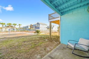 A balcony with a view of a beach and houses.