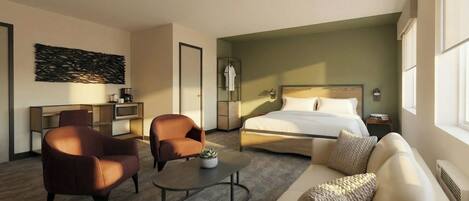 A modern hotel room with a bed, two armchairs, a sofa, a coffee table, and a desk with a lamp.