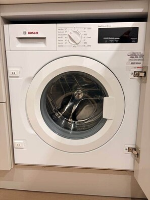 Una lavadora Bosch con panel de control, una perilla y una pantalla.
