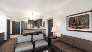 A modern living room with a sofa, a coffee table, and a dining area with a bench. - Park City, Ski-in, Ski-out, 2-bed 2 bath, Sleeps 8 (Park City)