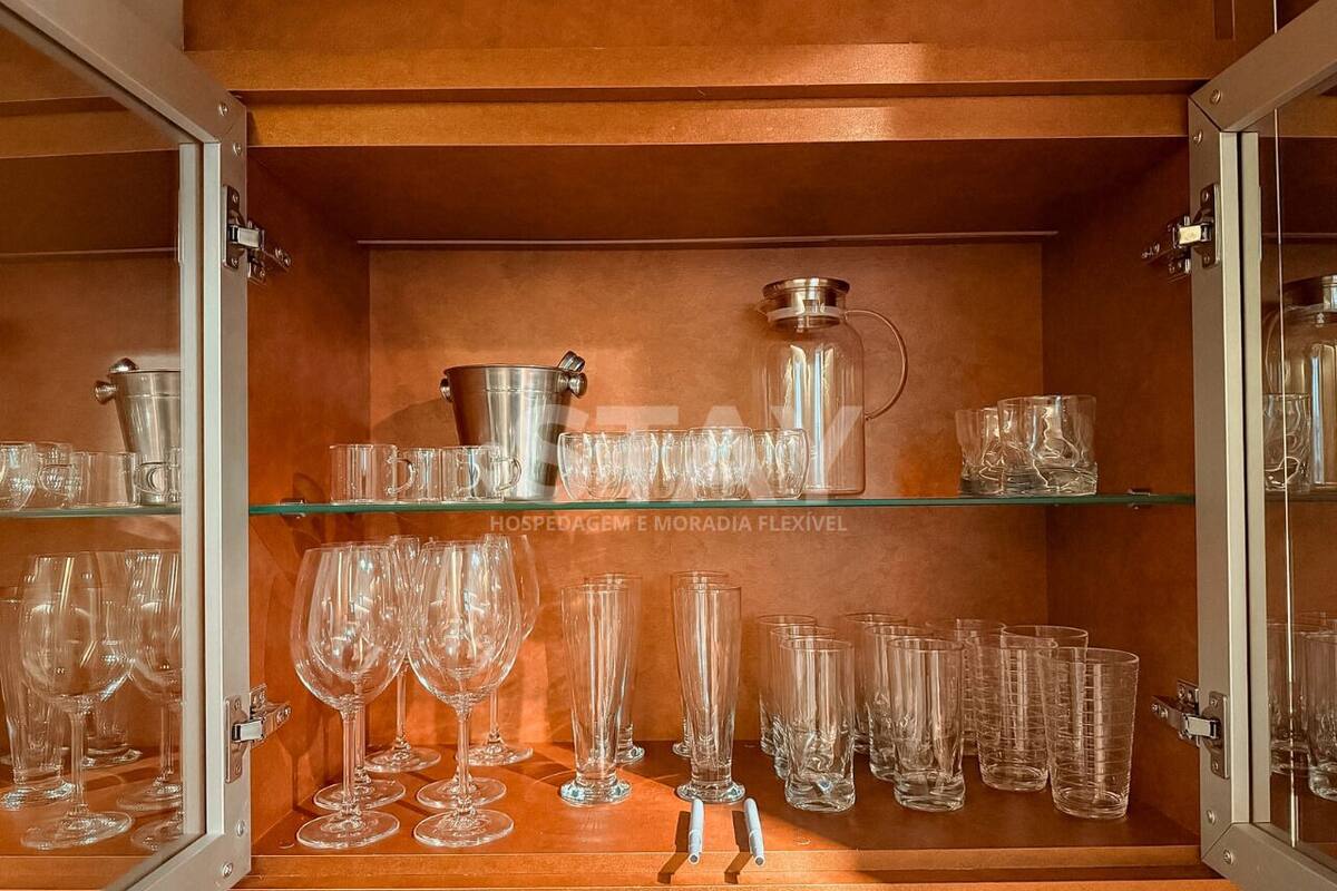 A display of clear glassware including wine glasses, water glasses, and tumblers, arranged on shelves.