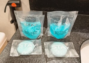 Four packages of shampoo and conditioner on a countertop. - STAY You by Fama (Palmas)