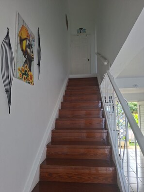 A wooden staircase with a white door at the top, leading to an outdoor area. - The Ultimate escape on beautiful Mahogany Beach, Ocho Rios (Ocho Rios)