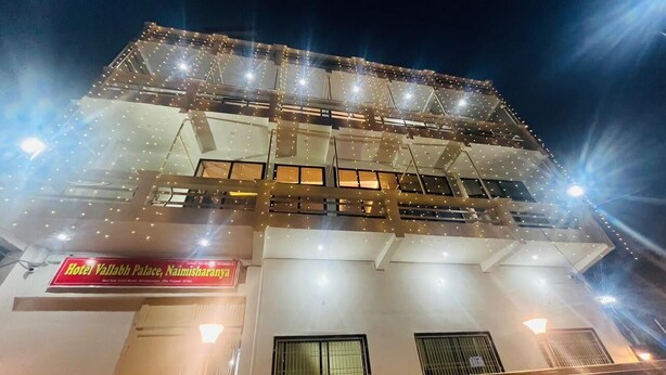 Hotel Vallabh Palace, Naimisharanyam, with a multi-story structure and a signboard. - Hotel Vallabh Palace (Misrikh)