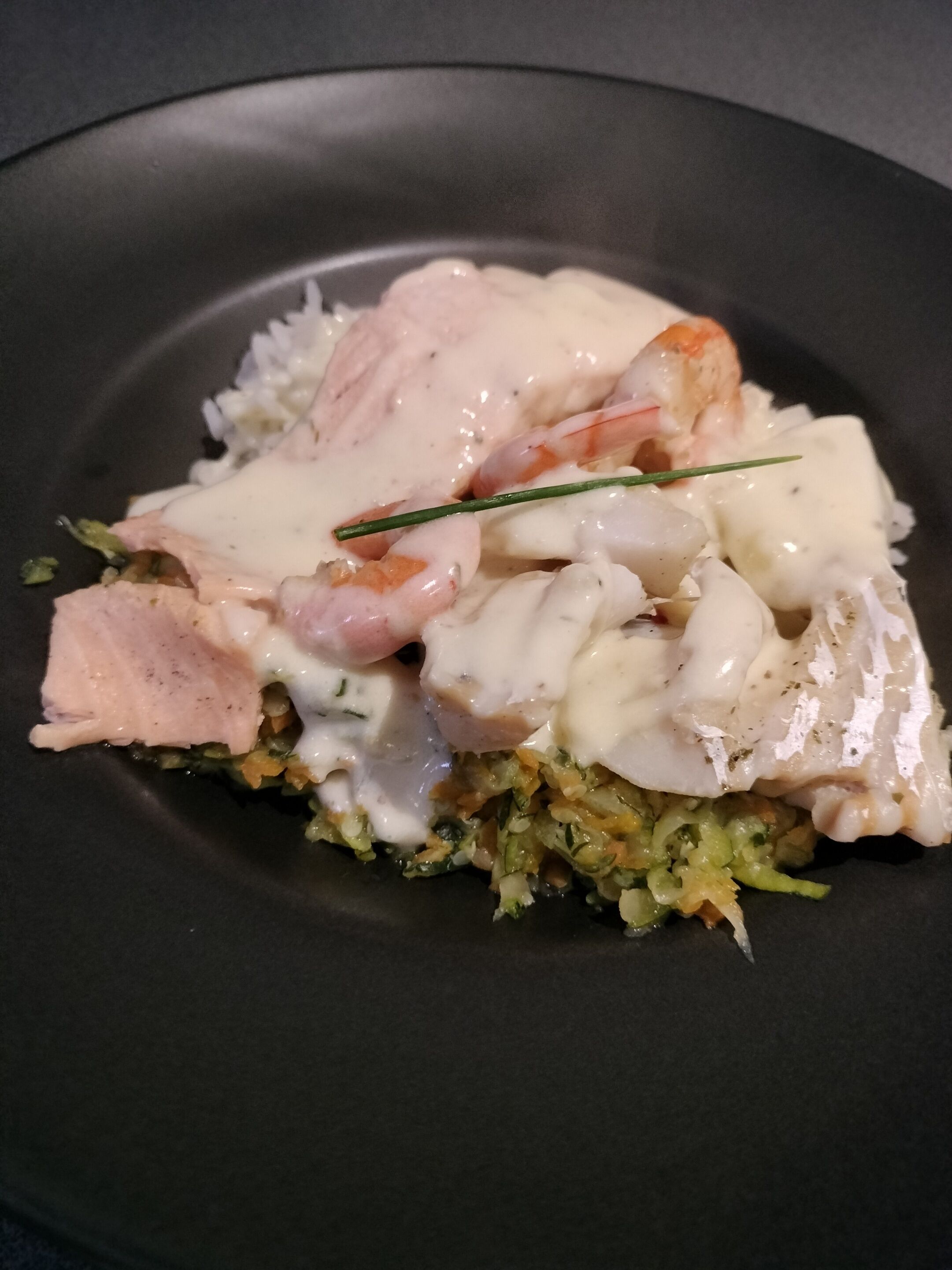 A plate of food with seafood and vegetables.