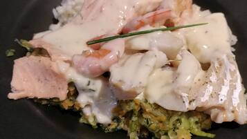 A plate of food with seafood and vegetables.