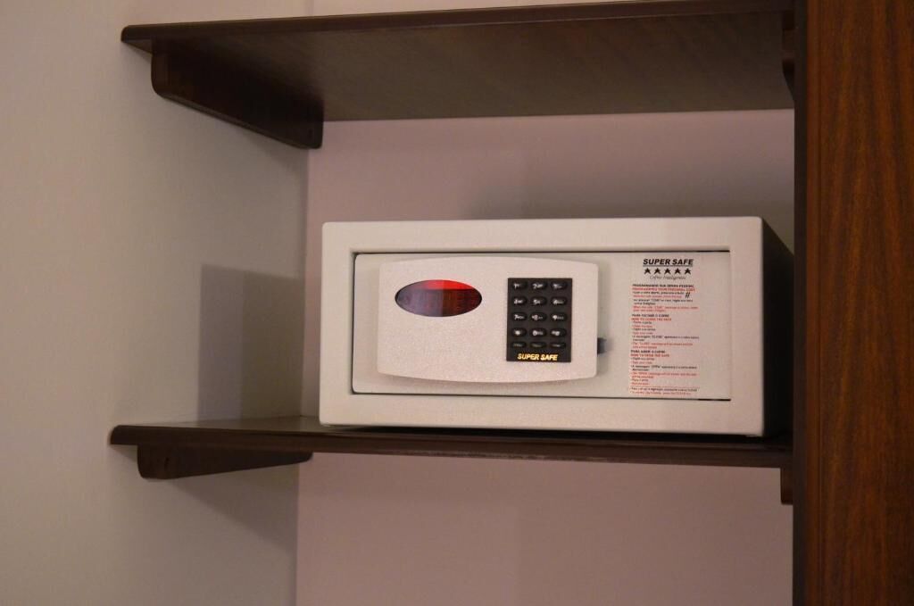 A microwave on a shelf in a room.