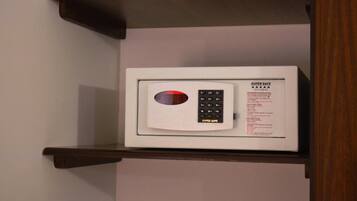 A microwave on a shelf in a room.