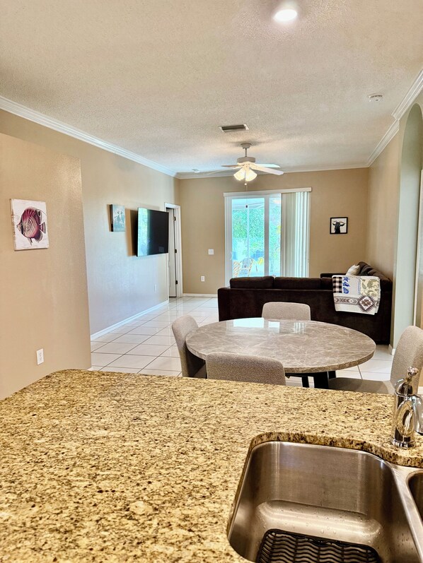 A kitchen with granite countertops and a stainless steel sink. - Spacious Retreat with Contemporary Comfort (Brandon)