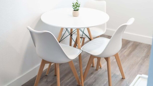 A round white table with two white chairs and a small potted plant. - Midtown 2 King| Near Roosevelt Row (Phoenix)