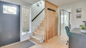 A staircase with wooden steps and a glass door leading to a room with a desk and chair. - 2-Story Guesthouse w/ Private Deck in NE PDX (Portland)