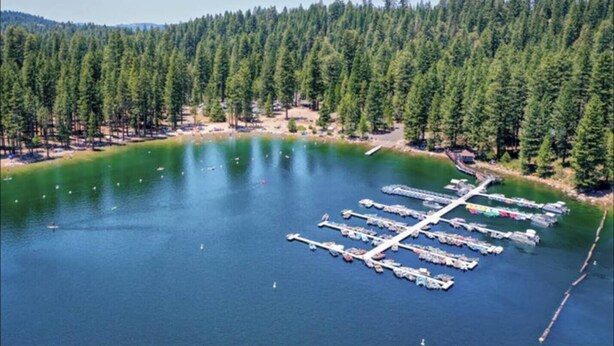 An aerial view of a marina surrounded by dense forest. - The Hide-Out! A Boho Cabin AC- Wi-fi (Mi-Wuk Village)