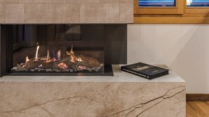A fireplace with a book on the mantel. - Luxury Chalet with Private Spa & Wellness Area (Megève)