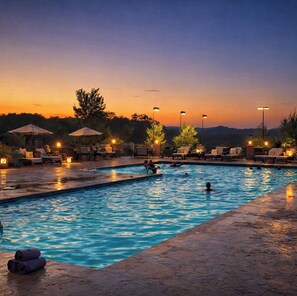 A swimming pool with lounge chairs and umbrellas, surrounded by trees and a fence. - 4 Ensuites, Championship Golf, Pool, Hottub, 30ft Patio with Outdoor Dining. (Branson)