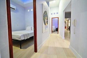 A hotel room with a bed, a painting, and a view of the hallway. - Walled City 5BR Colonial Home, Private Jacuzzi, 2 Balconies, Sleeps 12 (Cartagena de Indias)