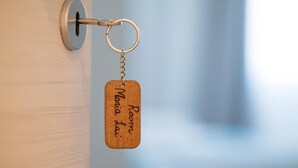 A wooden keychain with "Room Maria Lai" engraved on it, hanging on a door handle. - Room Maria Lai(I Centenari Longevity Rooms) Property located 1 km from the beach (Lotzorai)