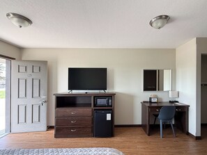 Desk, laptop workspace, blackout drapes, iron/ironing board