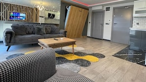 A modern living room with a sofa, a coffee table, and a patterned rug. - Ortaköy Suit (İstanbul)