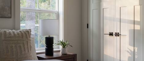 Soft light, forest views — your bedroom retreat awaits.