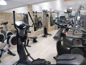 A gym with various exercise machines, including treadmills and elliptical trainers.