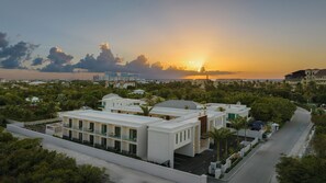A coastal resort with modern architecture, a marina, and a sunset view. - The Retreat Turks & Caicos (Providenciales)