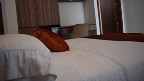 A hotel room with a bed, a desk, and a wardrobe. - Hotel Boutique Iyarí (Palmira)