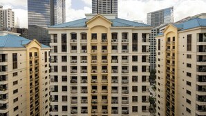 A high-rise hotel with multiple balconies, a central atrium, and a modern architectural design.